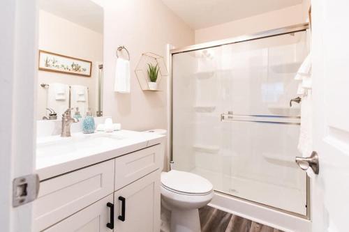 a white bathroom with a toilet and a shower at NorthPark-Professionals-Restaurants-King-Park-WiFi in San Diego