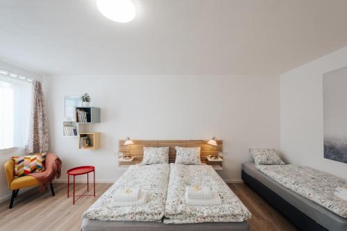 a bedroom with a large bed and a couch at Apartmán U Zámku - Apartment by the Castle in Blatná
