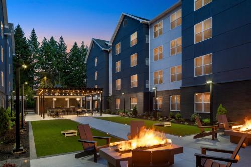 a courtyard with fire pits in front of a building at Homewood Suites Hillsboro Beaverton in Beaverton