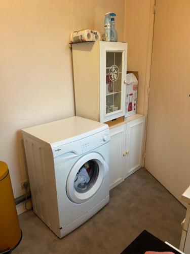 a washer and dryer sitting in a laundry room at Soso house in La Ferté-sous-Jouarre