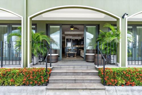 an entrance to a building with a staircase and plants at Luxury Condo with Panoramic Ocean Views, Sparkling Infinity Pool, and Modern Open-Concept Design in Playa Flamingo