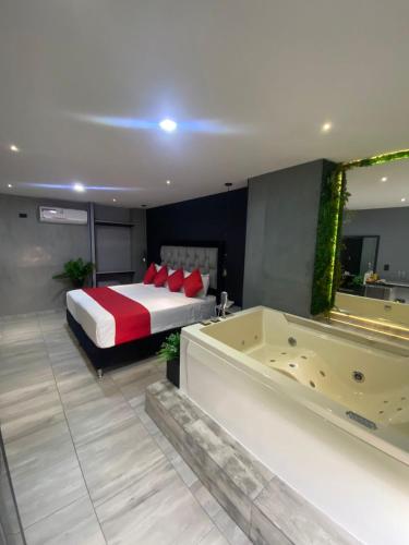 a bedroom with a bed and a bathtub and a tub at Hotel BRC in Bucaramanga