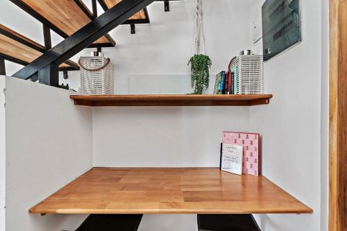 a wooden table on a wall with a shelf at Cozy Studio Close to Beach in Coco