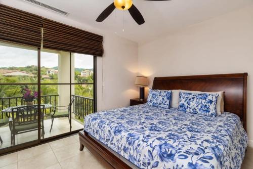 a bedroom with a bed and a balcony at 3-Bedroom 2-Bath Condo Overlooking Pool in Coco