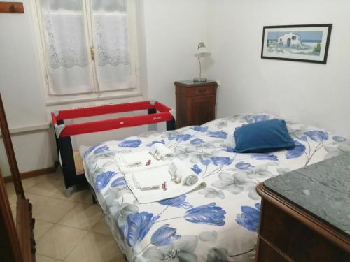 een slaapkamer met een bed en een rode bank bij La casetta nella Città dei due Mari in Sestri Levante