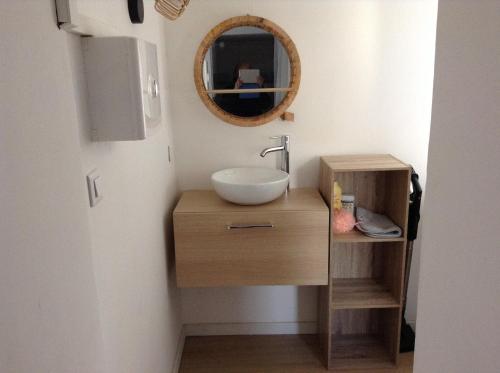 une salle de bain avec un lavabo et un miroir dans l'établissement la loggia, à Porto-Vecchio