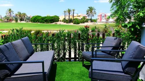 a group of chairs sitting on top of a lawn at Stunning groundfloor apartment - MO2802LT in Los Tomases
