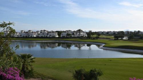 a view of a golf course with a lake at Apartment with pool & golf views - ER2113LT in Roldán