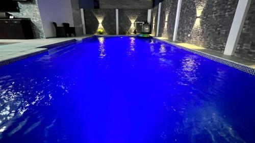 a swimming pool with blue water in a building at DaVinciHouse in San Pedro Sula