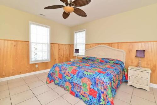 a bedroom with a bed and a ceiling fan at Tropical Rays Huge Cherry Grove House w Pool in Myrtle Beach