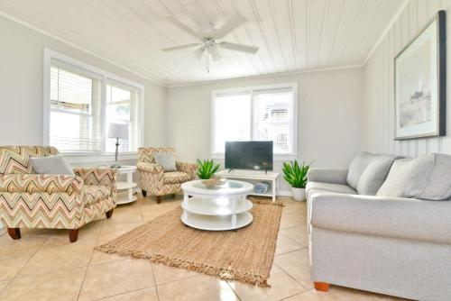 a living room with a couch and a tv at Hazels Castle Huge 2 in 1 Oceanfront House near Pier in Myrtle Beach