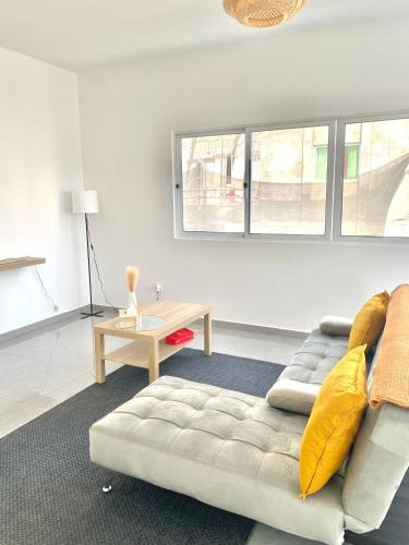 a living room with a couch and a table at Sea View & Balcony Modern Apartment in Pedra Badejo in Pedra Badejo