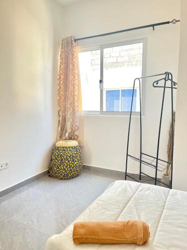 a bedroom with a bed and a window at Sea View & Balcony Modern Apartment in Pedra Badejo in Pedra Badejo