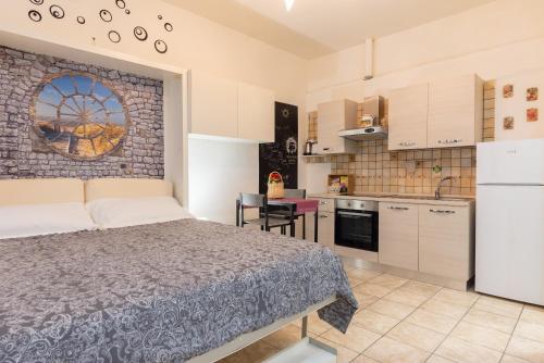 eine Küche und ein Schlafzimmer mit einem Bett in einem Zimmer in der Unterkunft Panariello a Portamedina in Neapel