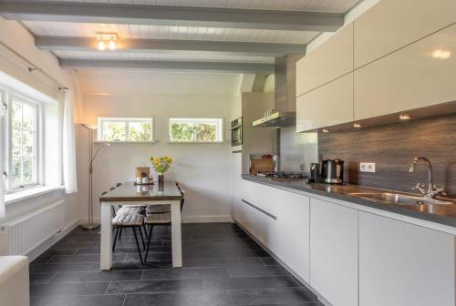 a kitchen with a table and a counter top at De Grote Schuur at Buitenplaats Zeeuwse Liefde in Westkapelle