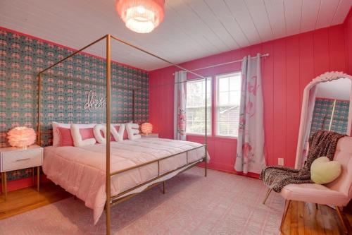 a pink bedroom with a bed and a chair at Inn the Pink One-in-a-Million Vacation Home in Myrtle Beach