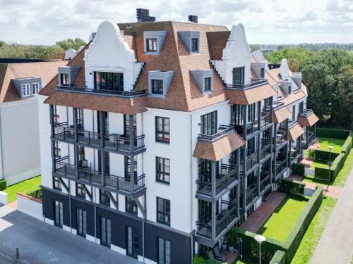 an aerial view of a large white building at Hello Zeeland - Duinhof V 1-7 in Cadzand