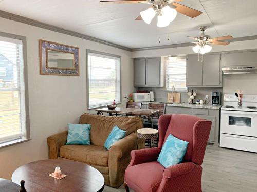 a living room with a couch and chairs and a kitchen at Beach Hut - Half Duplex Just a Few Blocks to Sand Shore and Jetty Park in Freeport