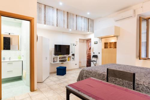 - une chambre avec un lit et une télévision dans l'établissement Panariello a Portamedina, à Naples