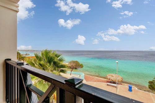 a view of the ocean from a balcony at Chachacha Apartment At Sea with Ocean View in Kralendijk