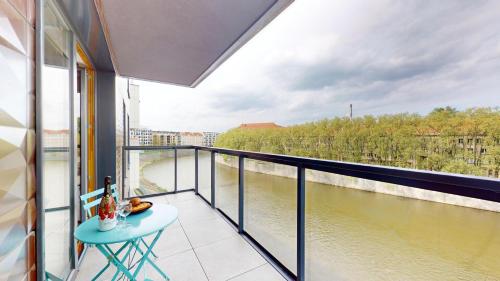 a balcony with a view of a river at WroApart Księcia Witolda in Wrocław