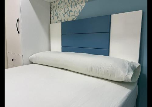 a bed with a white pillow on top of it at Princess resort in Hurghada