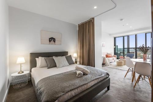 a bedroom with a large bed and a dining room at MA-a 1118 in Melbourne