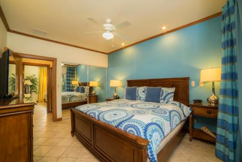 a bedroom with a large bed with blue walls at Los Suenos Resort Veranda 4F by Stay in CR in Herradura