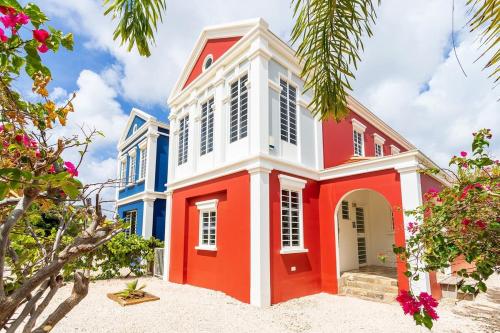 a house with red and blue paint at Kas Dive-In with Private Pool on the Laguna Marina in Kralendijk
