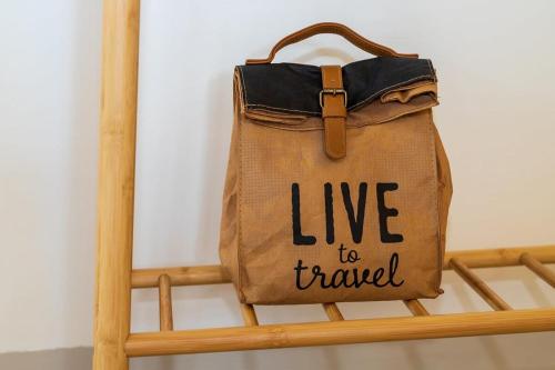 a bag with the words live to travel written on it at Kas Dive-In with Private Pool on the Laguna Marina in Kralendijk
