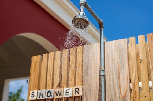 a water hose being used to clean a wooden fence at Kas Dive-In with Private Pool on the Laguna Marina in Kralendijk