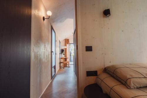 a bedroom with a bed and a hallway at Hello Zeeland - Vakantiehuis Kerkstraat 1A in Domburg