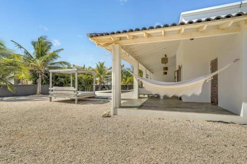 a hammock is hanging from the side of a house at Kas Kaprikornio with Lovely Cooling Private Pool in Kralendijk