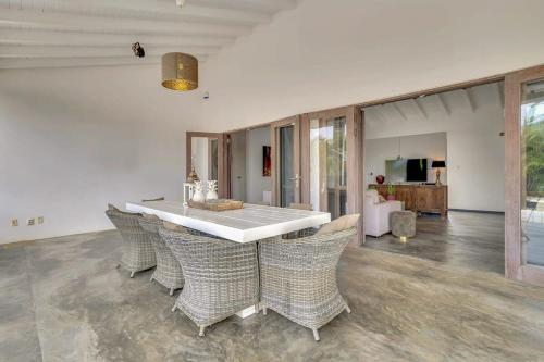 a dining room with a table and chairs at Kas Kaprikornio with Lovely Cooling Private Pool in Kralendijk