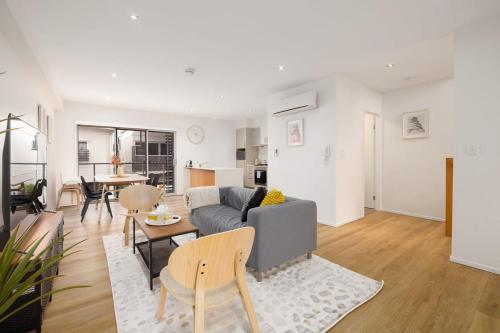 a living room with a couch and a table at Renov Peaceful 3BR Morningside Gem: Cozy Retreat in Brisbane