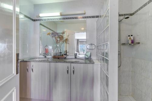 a bathroom with a sink and a shower at Port Bonaire Seascape A301 with Sea Views and Pool in Kralendijk