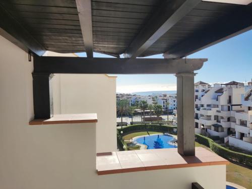 a balcony with a view of a pool and buildings at Urbanización Altos de Nuevo Vera in Vera
