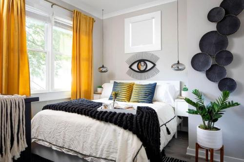a bedroom with a bed and a window with yellow curtains at Prospect in Atlanta