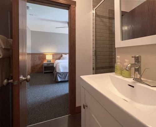 a bathroom with a sink and a room with a bed at Tekarra Lodge in Jasper