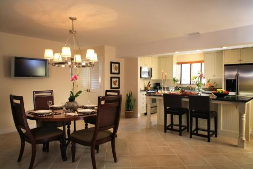 a dining room and kitchen with a table and chairs at West Beach Inn, a Coast Hotel in Santa Barbara