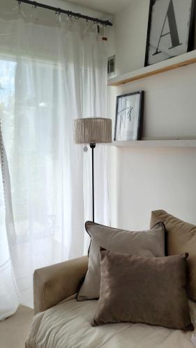 a living room with a couch and a window at Cala in Olavarría