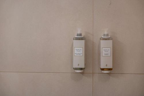 two white bottles on the wall of a bathroom at Best Western Hotel Armando in Verona