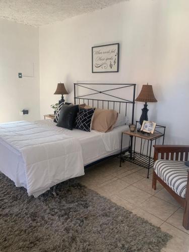 a bedroom with a large bed and a couch at Descansa y viaja bleseed house in Monte Adentro