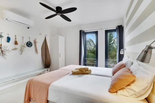 a bedroom with a bed with a ceiling fan at Villa Azul II in Belnem in Kralendijk