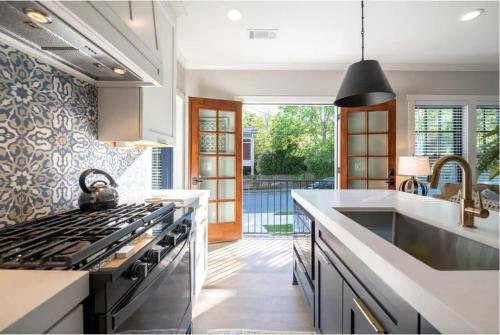 a kitchen with a stove and a sink at Butterfly Bungalow in Atlanta