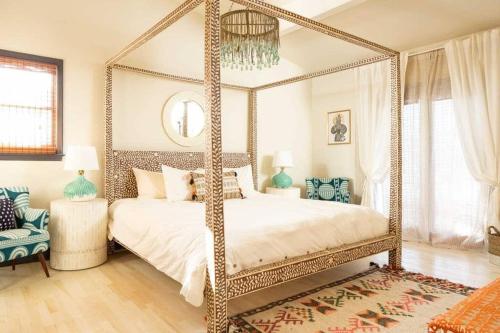 a bedroom with a four poster canopy bed at Boho Lux in Atlanta