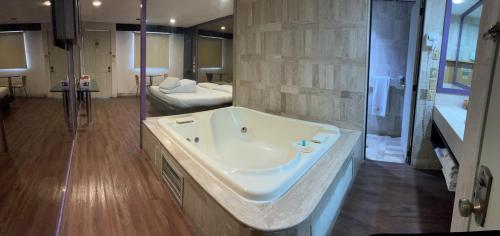 a large bathroom with a tub and a bedroom at Suites & Villas Real Hacienda in Ocoyoacac