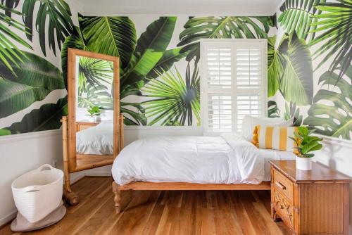 亞特蘭大的住宿－Boho Mod，一间卧室配有一张床和一张木叶壁画