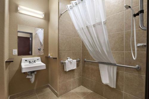 a bathroom with a sink and a shower at Sonesta Essential Gonzales TX in Gonzales