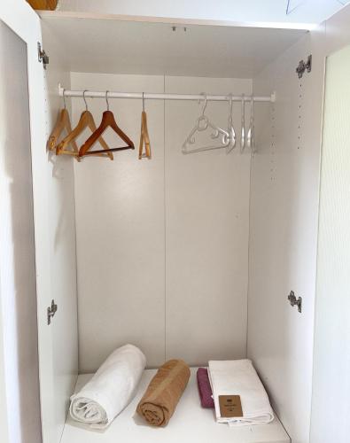 a walk in closet with towels and hangers at Villzone vila in Prishtina with big garden in Pristina